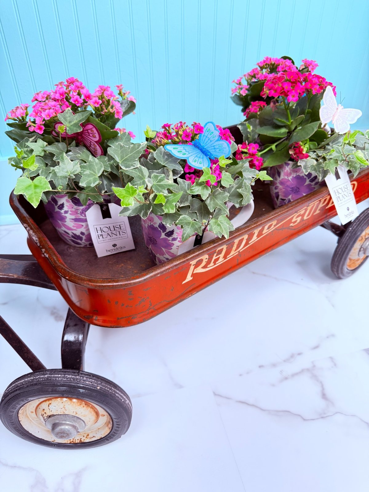 Potted flowers and plants in a vintage wagon